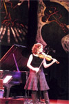 Violinist Jenny Scheinman plays in front of E.J. Gold's JazzArt